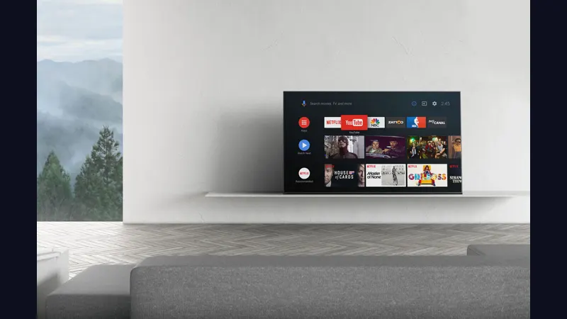 Living room television showing a streaming home screen with poster rows